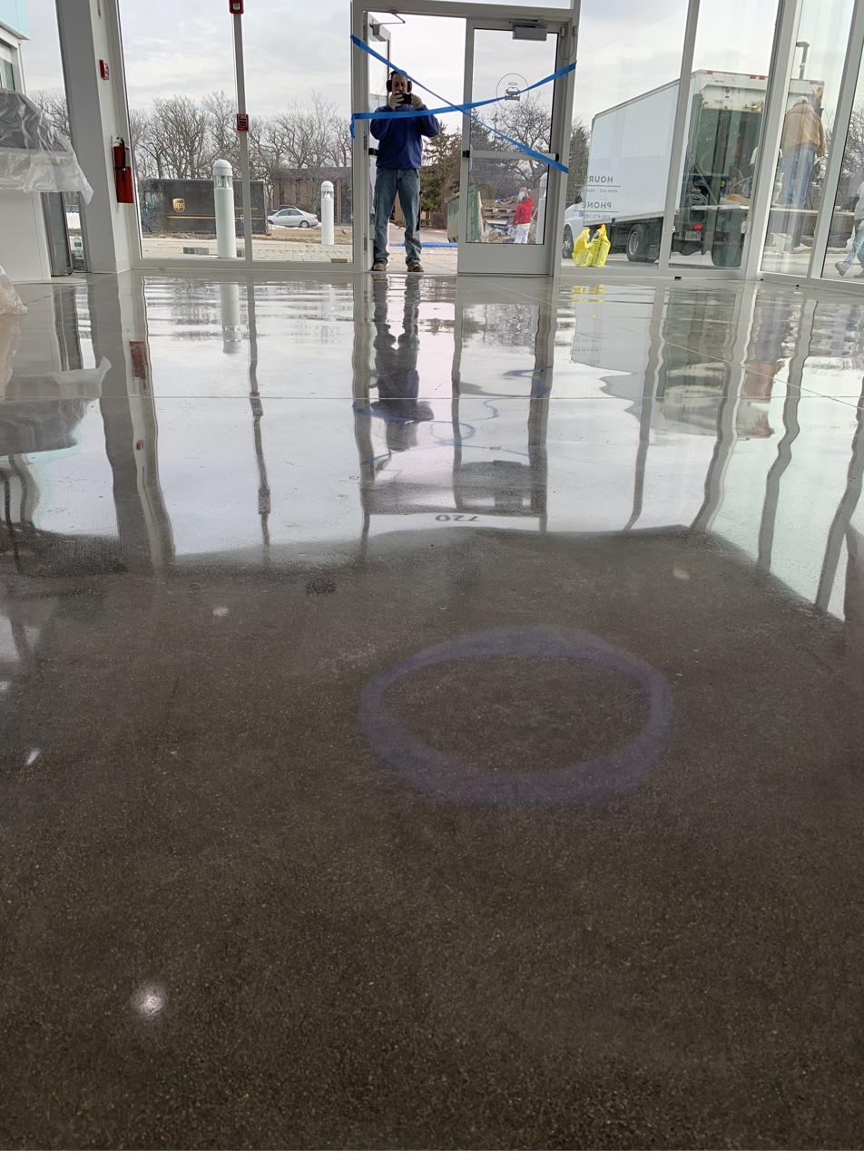 Reflective polished concrete floor in an auto dealership showroom